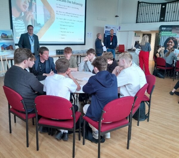Group discussion with students round a table 