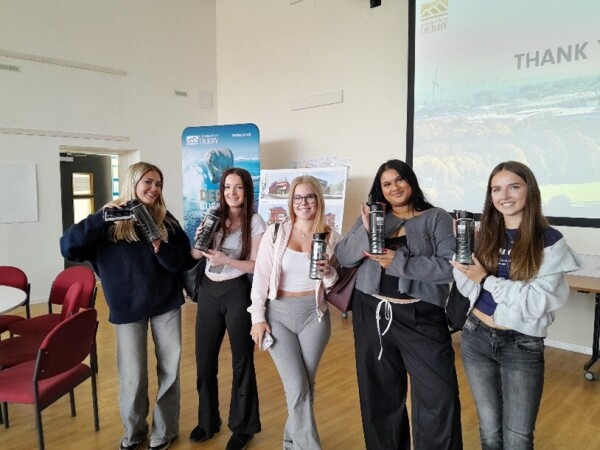 Five students holding a prize